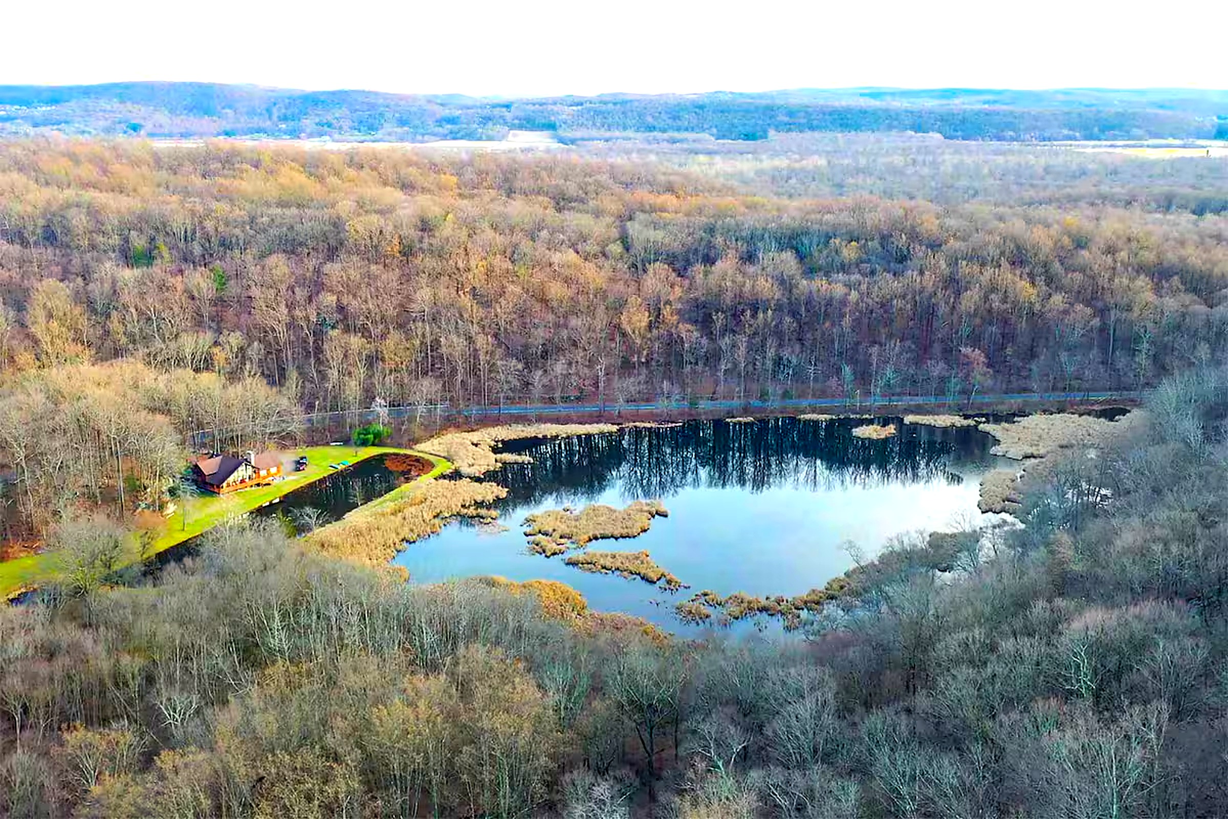 Aerial view of cabin and pond